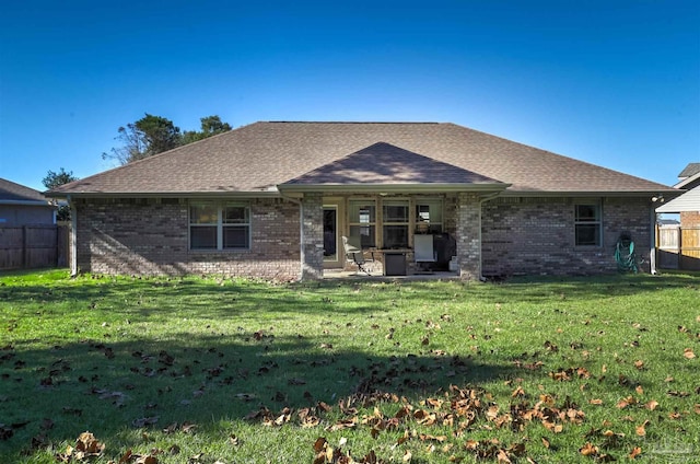 back of house with a patio area and a lawn