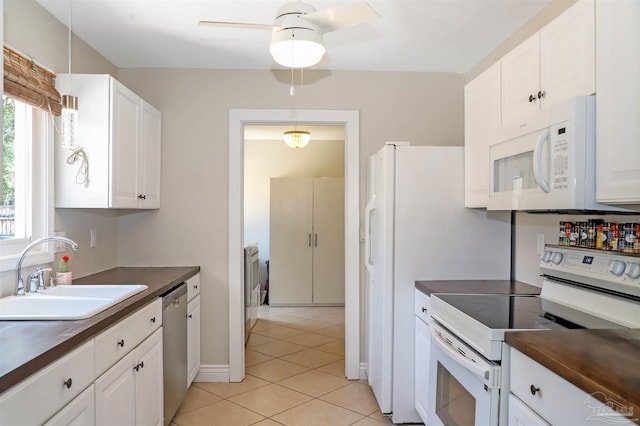 kitchen featuring sink, pendant lighting, white cabinetry, butcher block countertops, and white appliances