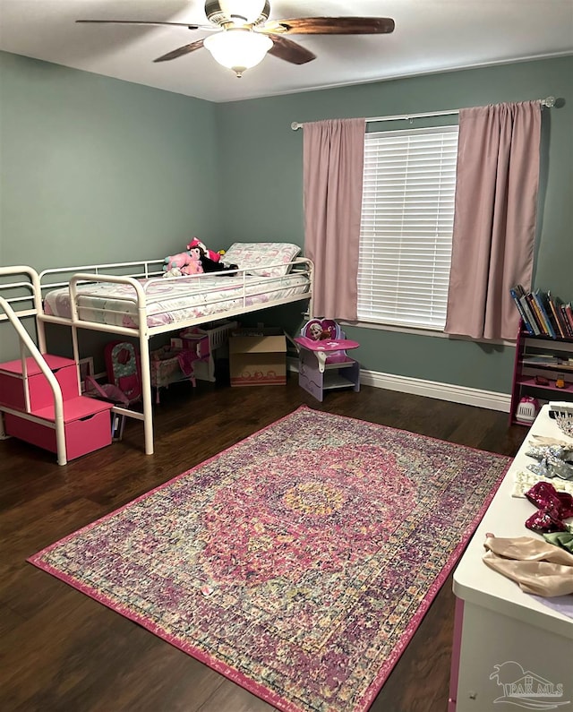 bedroom with ceiling fan and dark hardwood / wood-style floors