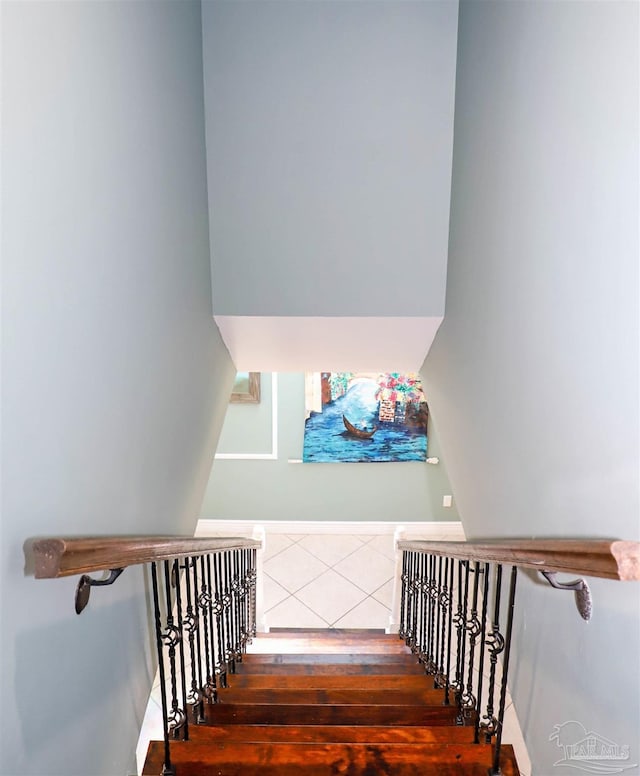 staircase with hardwood / wood-style flooring