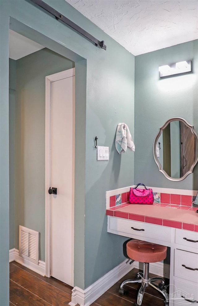 bathroom with hardwood / wood-style floors