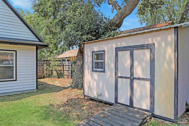 view of outbuilding featuring a lawn