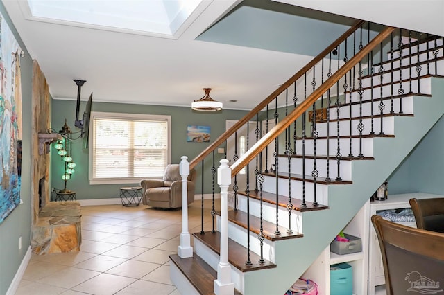 stairs featuring a skylight and tile patterned flooring