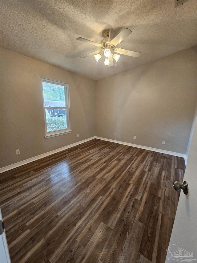 empty room featuring dark hardwood / wood-style floors, a textured ceiling, and ceiling fan