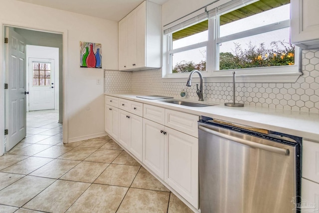 kitchen featuring white cabinets, light tile patterned floors, sink, and dishwasher