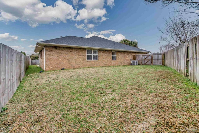 back of house featuring cooling unit and a yard