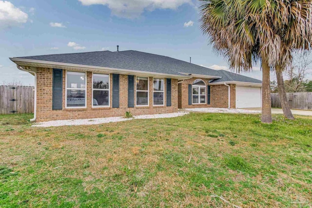 ranch-style home with a garage and a front lawn