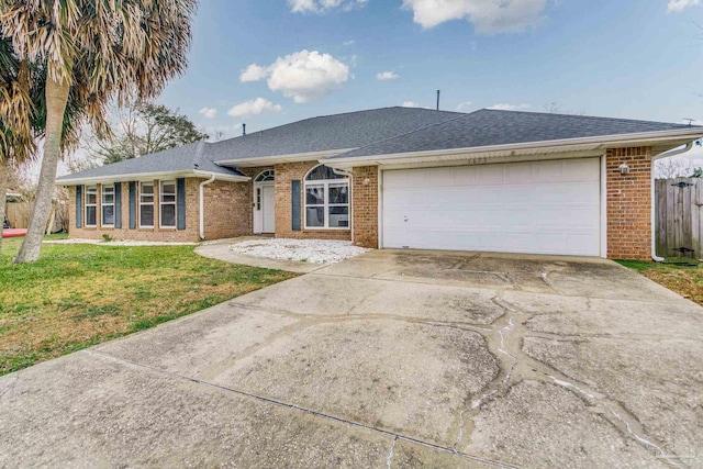 ranch-style house with a garage and a front lawn