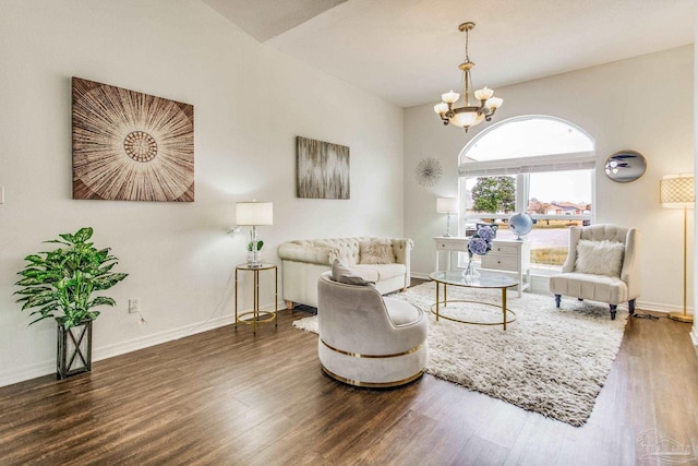 living room with dark hardwood / wood-style flooring and a chandelier