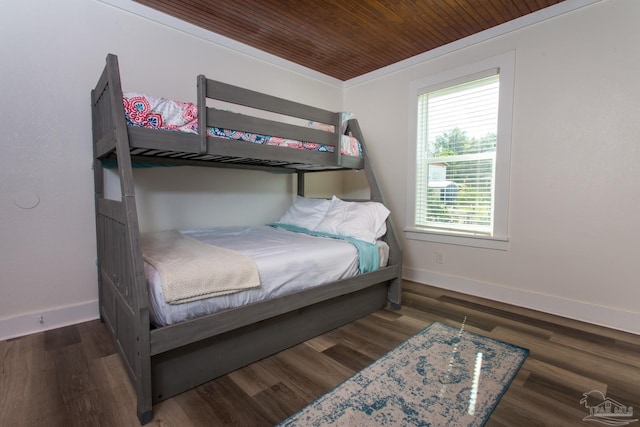 bedroom with wood ceiling, wood finished floors, and baseboards