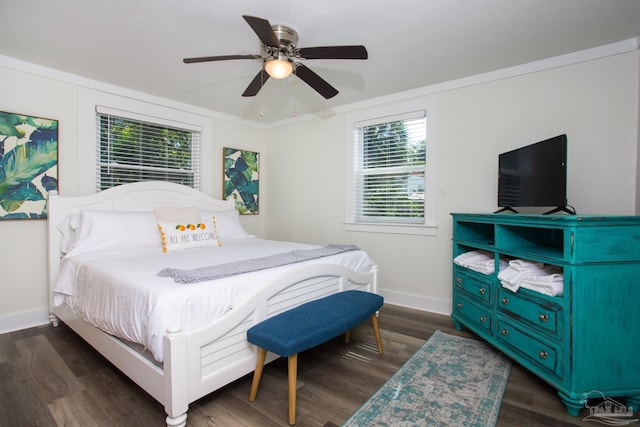 bedroom with a ceiling fan, baseboards, dark wood-style flooring, and ornamental molding