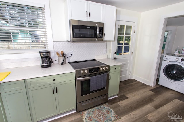 kitchen featuring washer / dryer, stainless steel appliances, light countertops, green cabinets, and tasteful backsplash