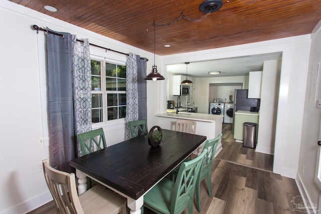 dining space featuring wooden ceiling, baseboards, independent washer and dryer, and dark wood-style flooring