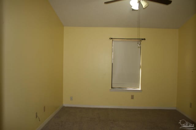 carpeted empty room featuring vaulted ceiling and ceiling fan