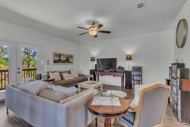 living area featuring visible vents, ceiling fan, and wood finished floors