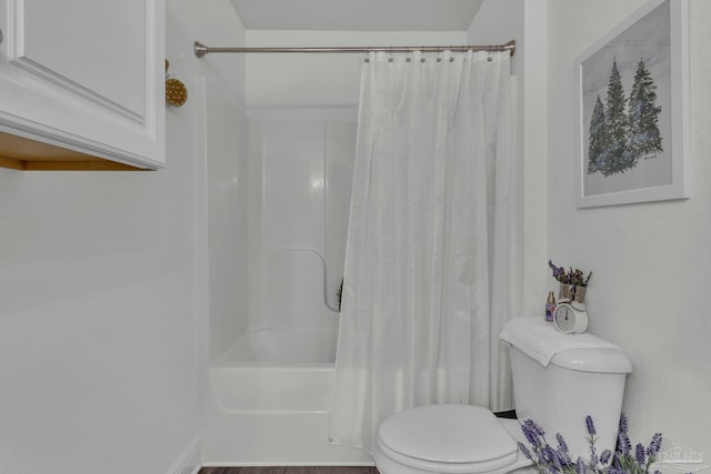 bathroom with toilet and shower / tub combo with curtain