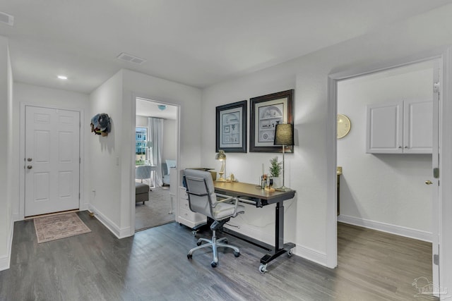 home office featuring visible vents, baseboards, and wood finished floors