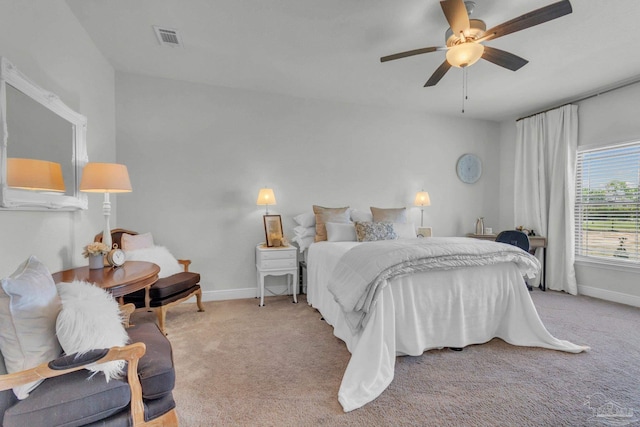 bedroom featuring light carpet, baseboards, a ceiling fan, and visible vents