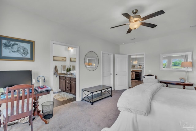 bedroom featuring ensuite bath, visible vents, dark carpet, and a ceiling fan
