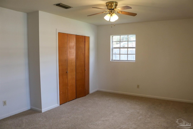 unfurnished bedroom featuring a closet, carpet, and ceiling fan