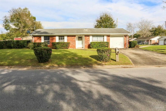 ranch-style house with a garage and a front yard