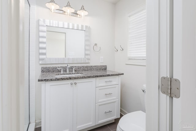 bathroom featuring tile patterned flooring, vanity, and toilet