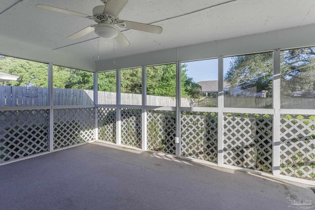 unfurnished sunroom with ceiling fan