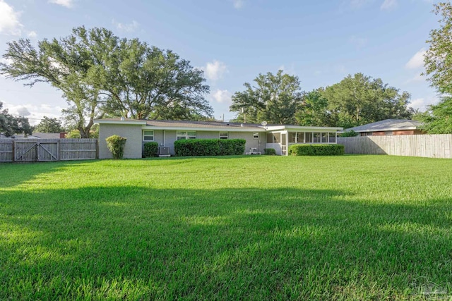 back of house featuring a yard