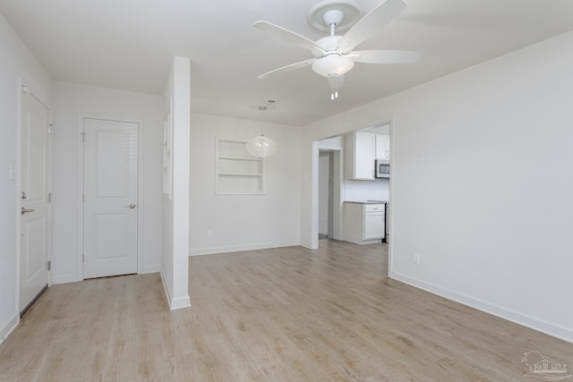 unfurnished room featuring ceiling fan and light hardwood / wood-style floors