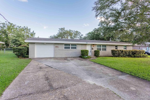 single story home with a front yard and a garage