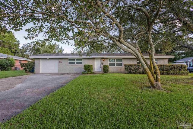 ranch-style house with a garage and a front yard