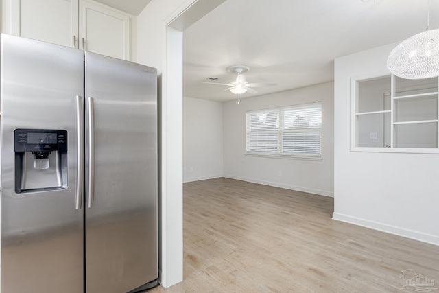 kitchen with light hardwood / wood-style flooring, stainless steel fridge with ice dispenser, ceiling fan, and white cabinets