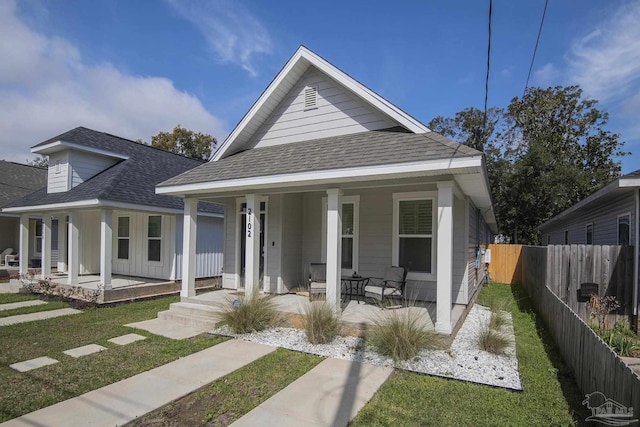 bungalow with a front yard and a porch