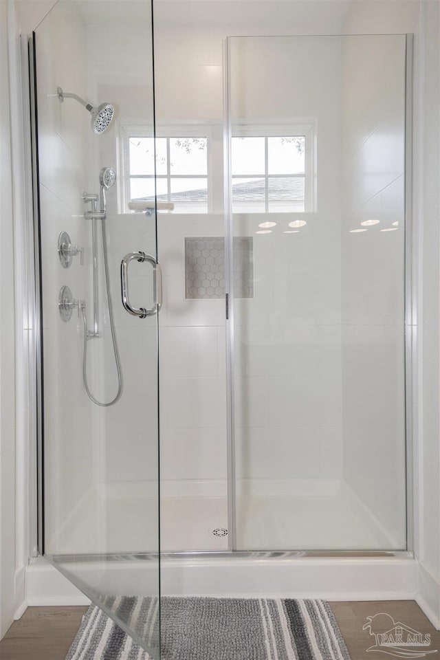 bathroom featuring wood-type flooring and walk in shower