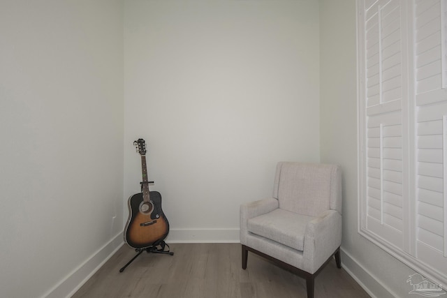 sitting room with wood-type flooring