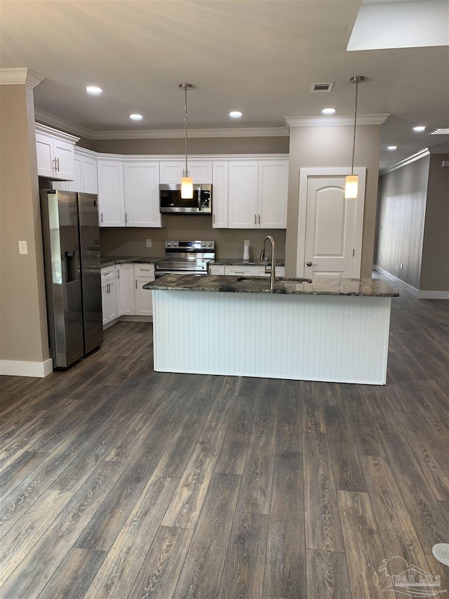 kitchen with appliances with stainless steel finishes, visible vents, a sink, and crown molding