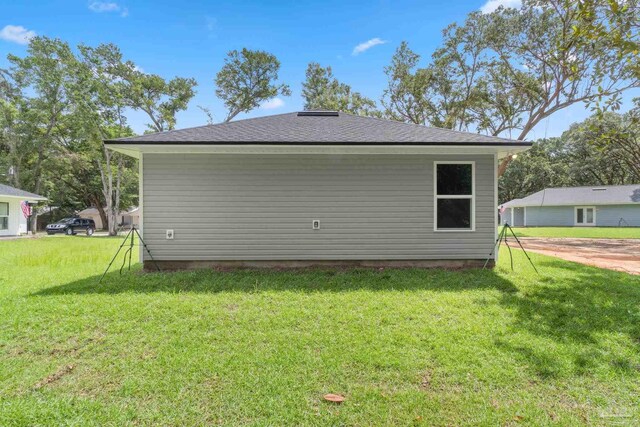 view of side of property with a lawn