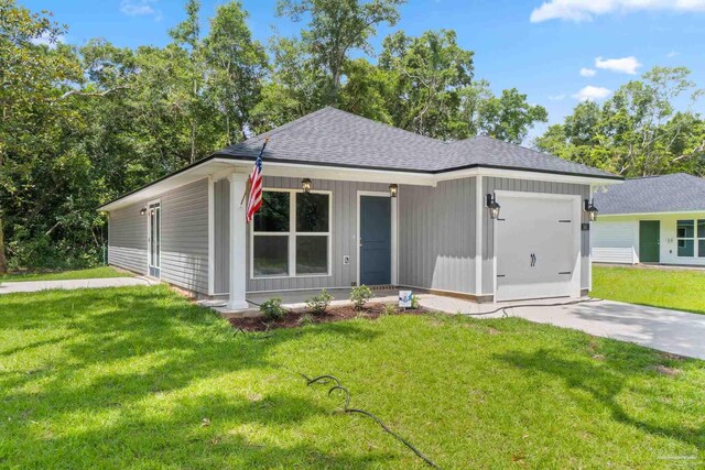 ranch-style house featuring a garage and a front lawn