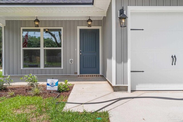 doorway to property with a garage