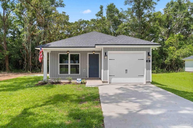 view of front of home featuring a garage and a front lawn