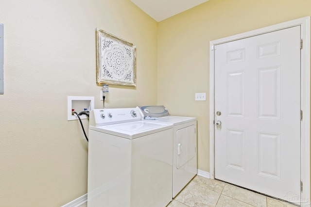 laundry area with light tile patterned floors and washing machine and clothes dryer