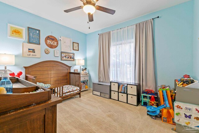 bedroom with light colored carpet and ceiling fan