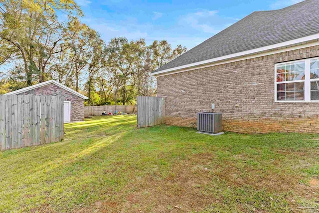 view of yard with a storage unit and central air condition unit