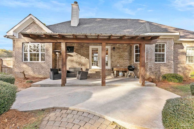 rear view of property with an outdoor hangout area and a patio area