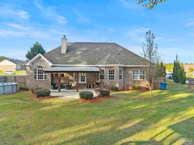 back of property featuring a yard and a patio