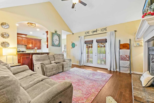 living room with ceiling fan, french doors, high vaulted ceiling, and dark wood-type flooring