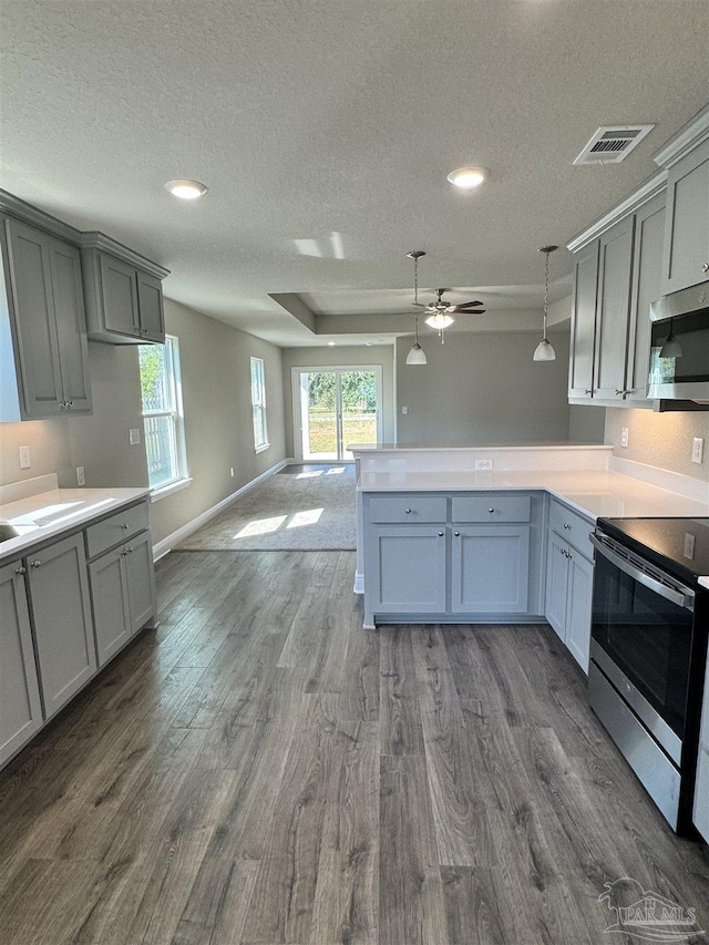 5963 Laurel Oak Dr, Pensacola, FL 32526 - kitchen with appliances with stainless steel finishes, a textured ceiling, open floor plan, dark wood-style flooring, and ceiling fan