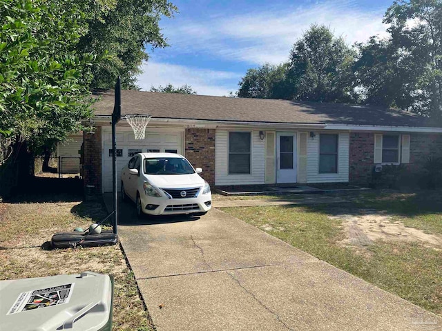 single story home featuring a garage and a front lawn