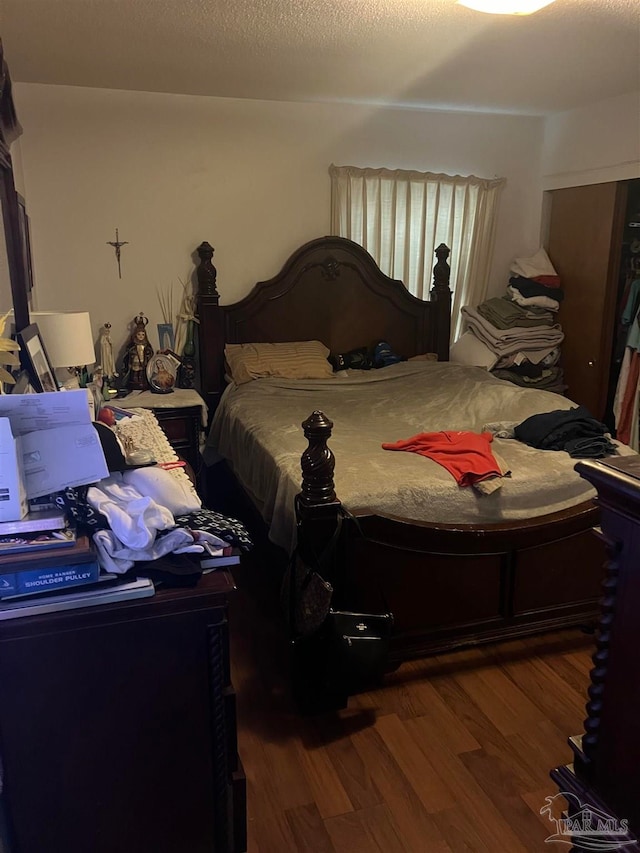 bedroom with wood-type flooring