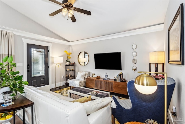 living room with ceiling fan, vaulted ceiling, ornamental molding, and wood-type flooring